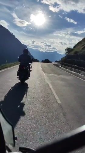 Scooter ride through a sunny mountain road in Ropsang
