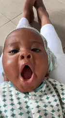 Baby in jeweled headband photographed in Badagry, Nigeria