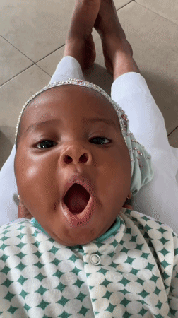 Baby in jeweled headband photographed in Badagry, Nigeria