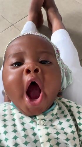 Baby in jeweled headband photographed in Badagry, Nigeria