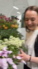 Woman explores flower display in Kragujevac market