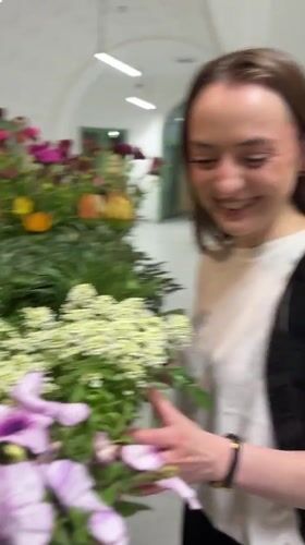 Woman explores flower display in Kragujevac market