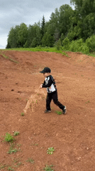 Children play in dirt field in Al'nyash, Russia