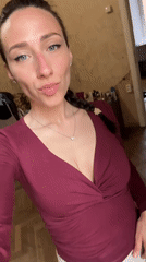 Woman takes selfies in maroon shirt in Saint Petersburg