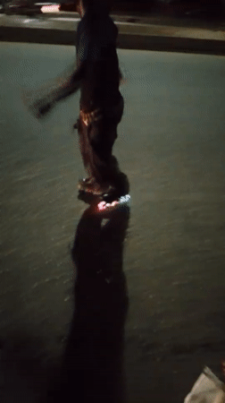 LED-lit roller skater glides through Nigeria night market streets
