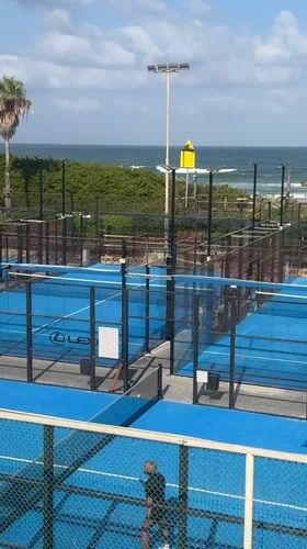 Choppy surf and beach crowds at Herzliya on a summer morning