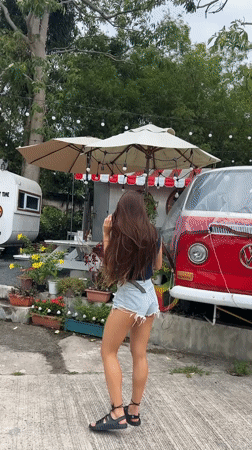 Woman explores quiet Thai fishing village on overcast morning