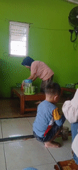 Morning scene at a small green-walled food stall in Sumber Rejo