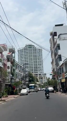 Street scene documented in Nha Trang featuring BAVICO building