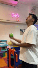 Man juggles colorful balls in Catamarca, Argentina room
