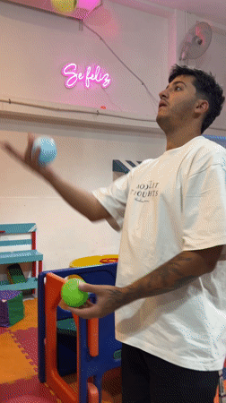 Man juggles colorful balls in Catamarca, Argentina room