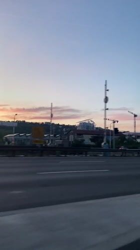 Dawn highway drive captured near Lyon with moonlit sky
