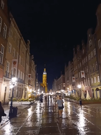 Nighttime canal streets lead into a red-lit European bar