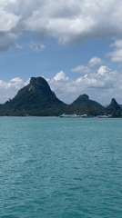 Boat passenger films serene tropical waters near Don Sak