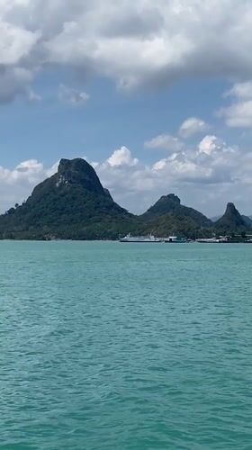 Boat passenger films serene tropical waters near Don Sak
