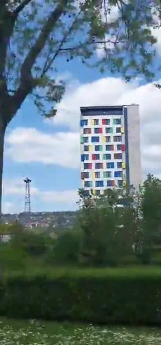 Modern residential building documented in Sarajevo under cloudy skies