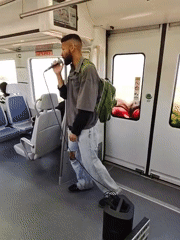Man performs with microphone on train