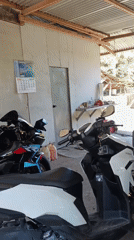 Motorcycles parked in sunny residential garage captured on video