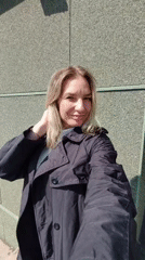 Woman in polka dot skirt takes outdoor selfies