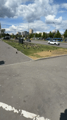 Pigeon flock gathers in Moscow urban area, worker paints nearby