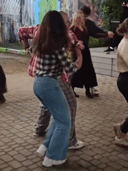 Rainy evening dance gathering at an outdoor Minsk venue