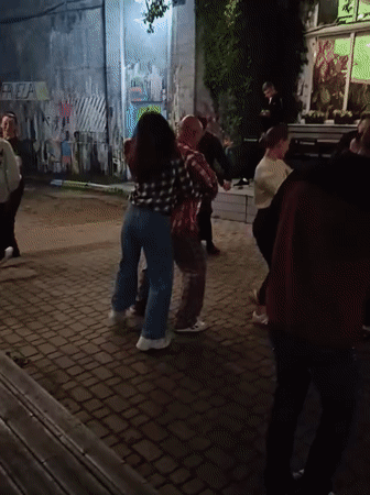 Rainy evening dance gathering at an outdoor Minsk venue