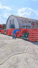 Beverage crates stacked in outdoor storage yard in Velika