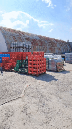 Beverage crates stacked in outdoor storage yard in Velika