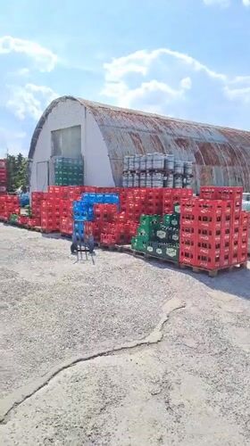 Beverage crates stacked in outdoor storage yard in Velika