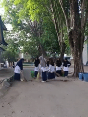 Students conduct nighttime cleanup at Lhokseumawe school courtyard