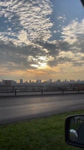 Golden sunrise captured over Iquique cityscape from moving vehicle
