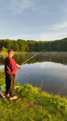 Quiet sunrise fishing session at a misty lakeside