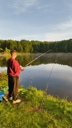 Quiet sunrise fishing session at a misty lakeside