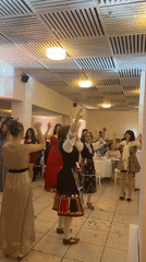 Traditional Bulgarian folk dancers perform at wedding reception