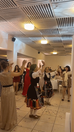 Traditional Bulgarian folk dancers perform at wedding reception