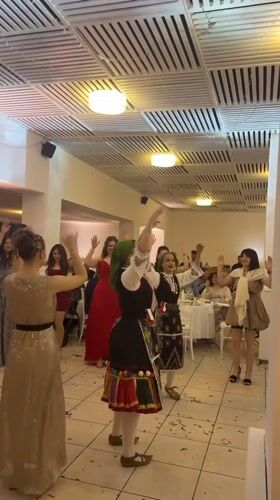 Traditional Bulgarian folk dancers perform at wedding reception
