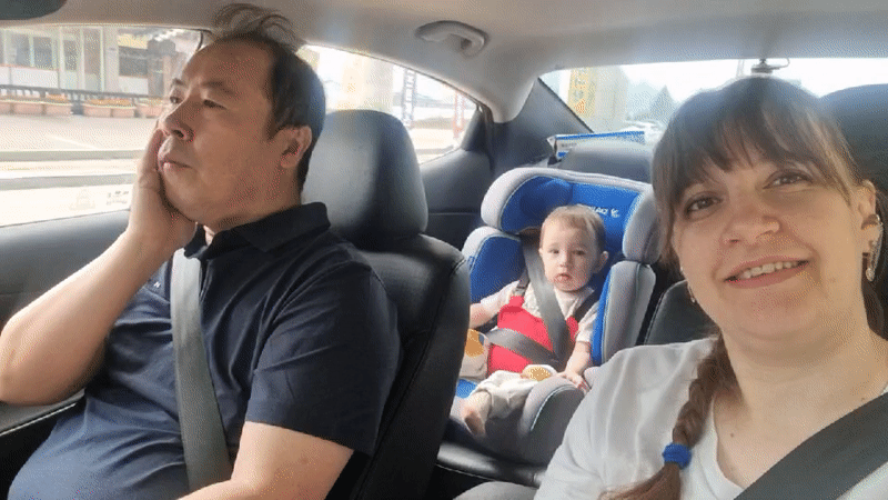 Family observed resting in car backseat in South Korea