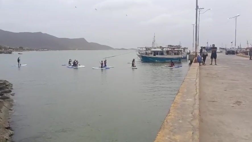 Paddleboarders enjoy calm waters in Juan Griego Bay, Venezuela