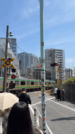 Early morning train crossing activity documented in Shibuya