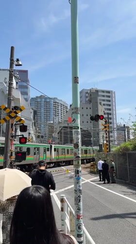 Early morning train crossing activity documented in Shibuya
