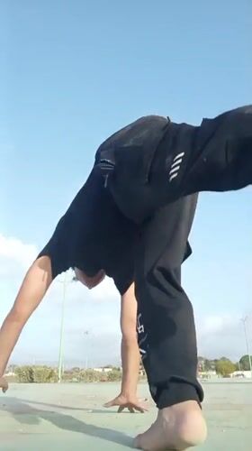 Man performs outdoor calisthenics routine in Juan Griego, Venezuela
