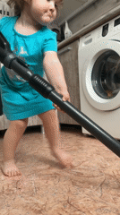Toddler helps with morning chores in Chaikovsky home