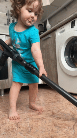 Toddler helps with morning chores in Chaikovsky home