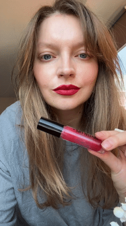 Woman applies Krystal Lips gloss in Izhevsk beauty moment