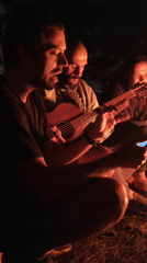 Nighttime campfire gathering with music in Lạc Dương, Vietnam