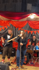 Band performs at outdoor gathering with campfire in Buenos Aires