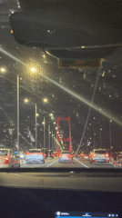 Night traffic crosses illuminated bridge in Istanbul's Beşiktaş district
