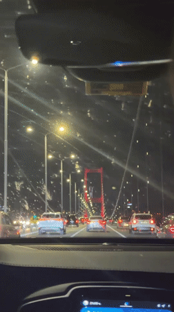 Night traffic crosses illuminated bridge in Istanbul's Beşiktaş district