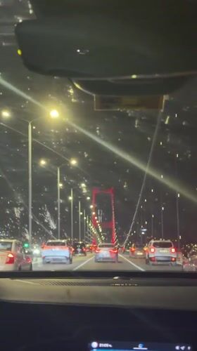 Night traffic crosses illuminated bridge in Istanbul's Beşiktaş district