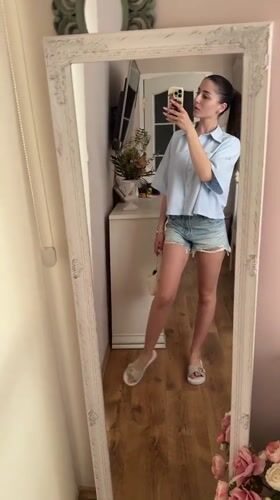 Woman takes mirror selfies with dog in Targovishte home